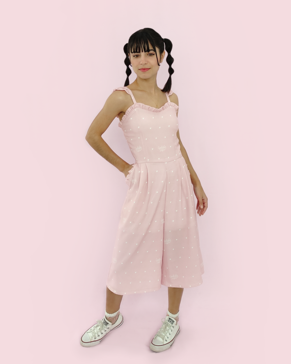Model wearing pink polyester overalls with heart print by meliekstea