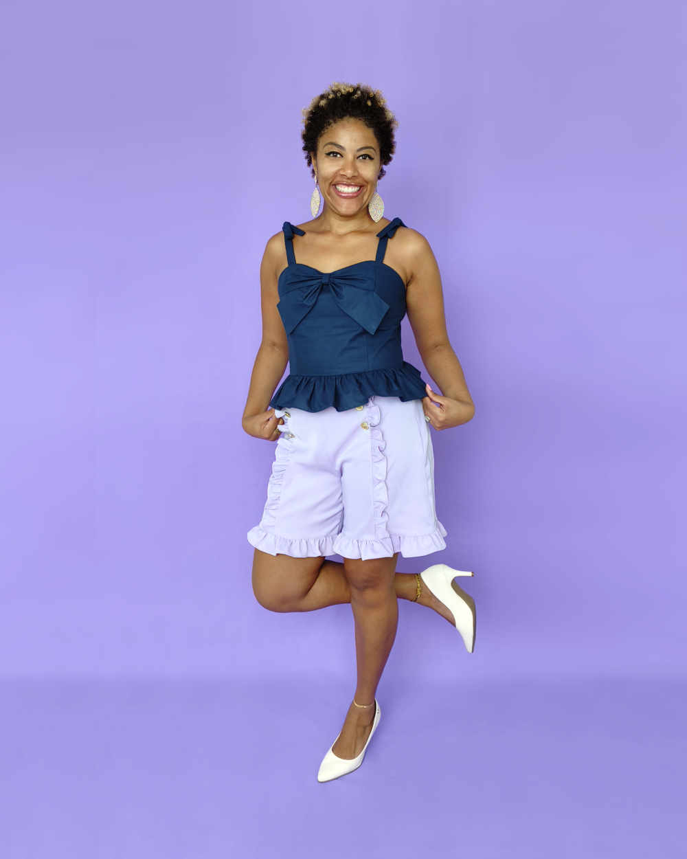 Model wearing Ruffled bow strap cotton top in navy color, full back shirring and bow on the bust.