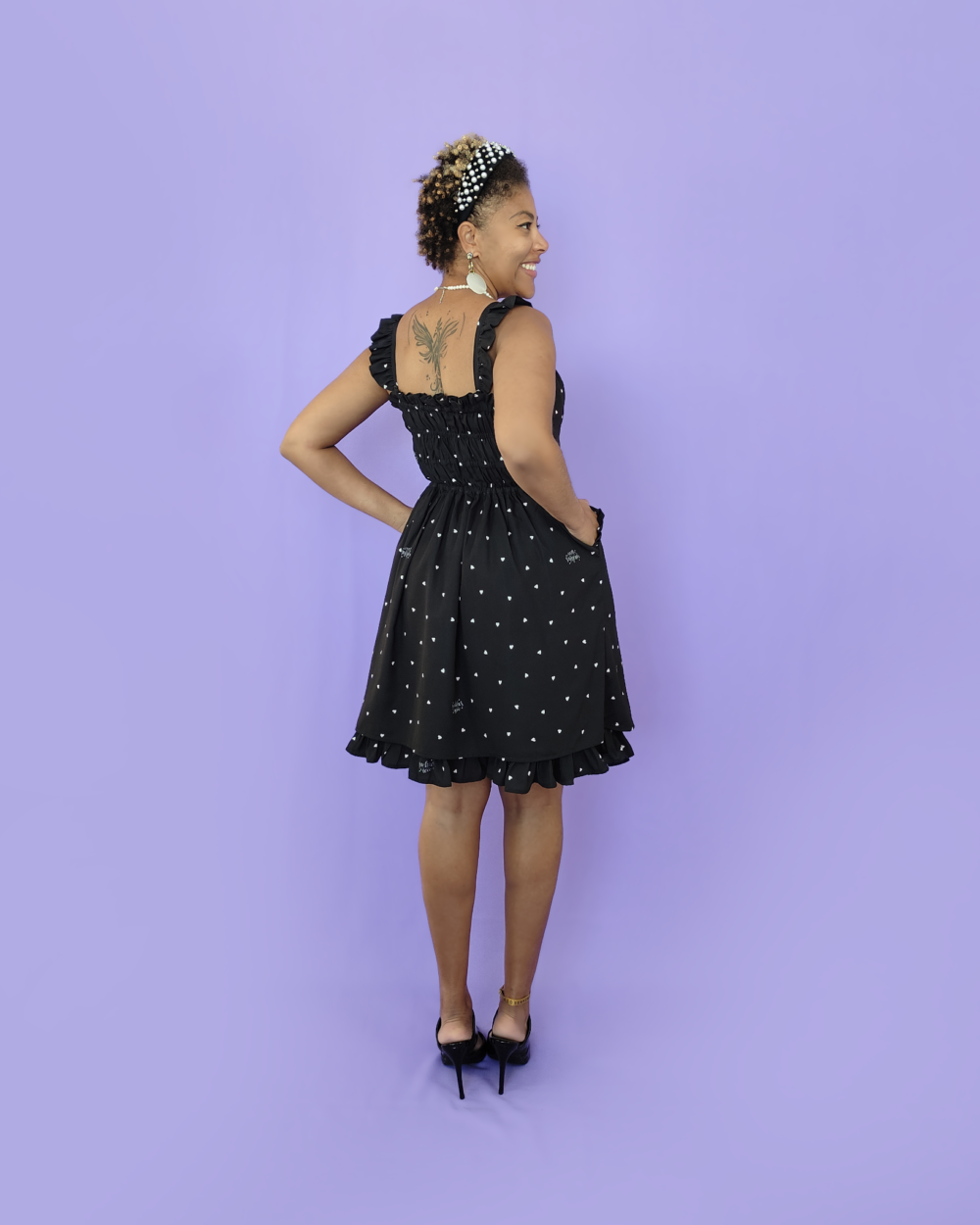 Model wearing a black dress with a heart print by melikestea